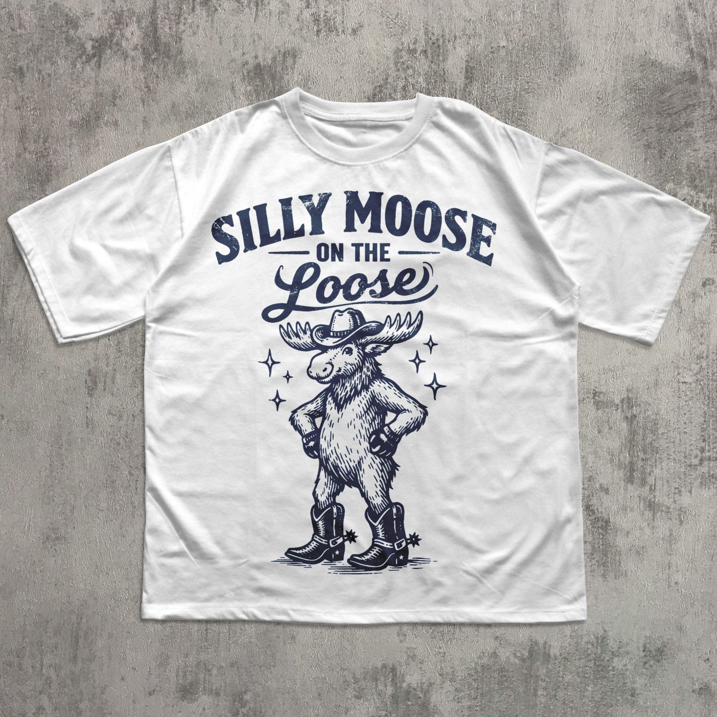 White t-shirt with 'Silly Moose on the Loose' graphic design on a concrete surface