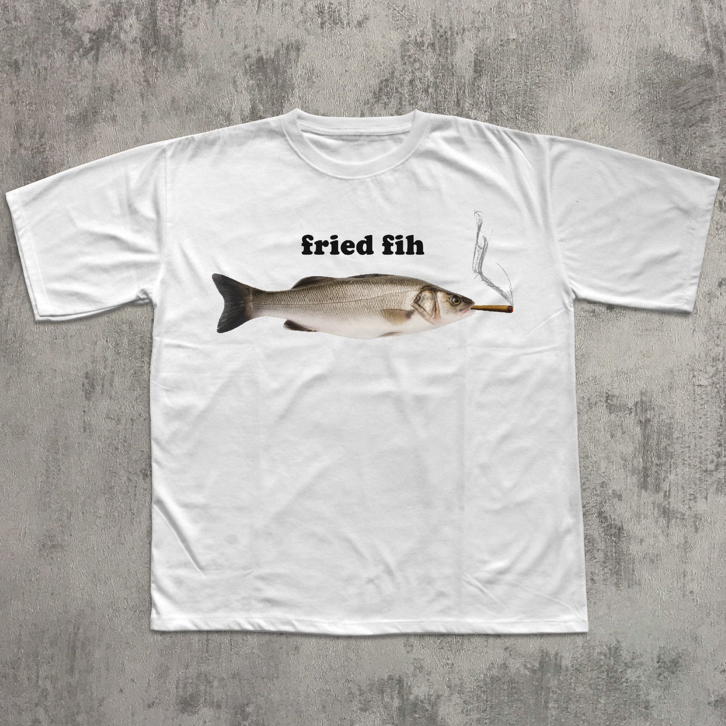 White t-shirt with a graphic of a fish and the text 'fried fih' on a textured gray background