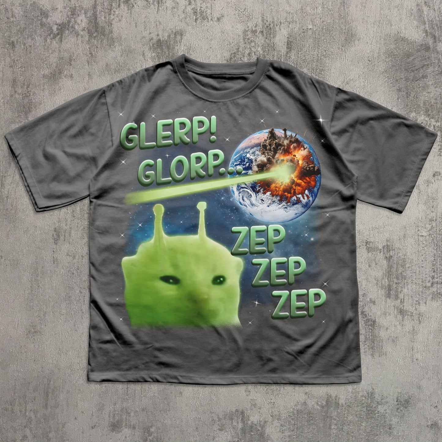 Gray t-shirt with a green alien and space-themed design on a textured gray background