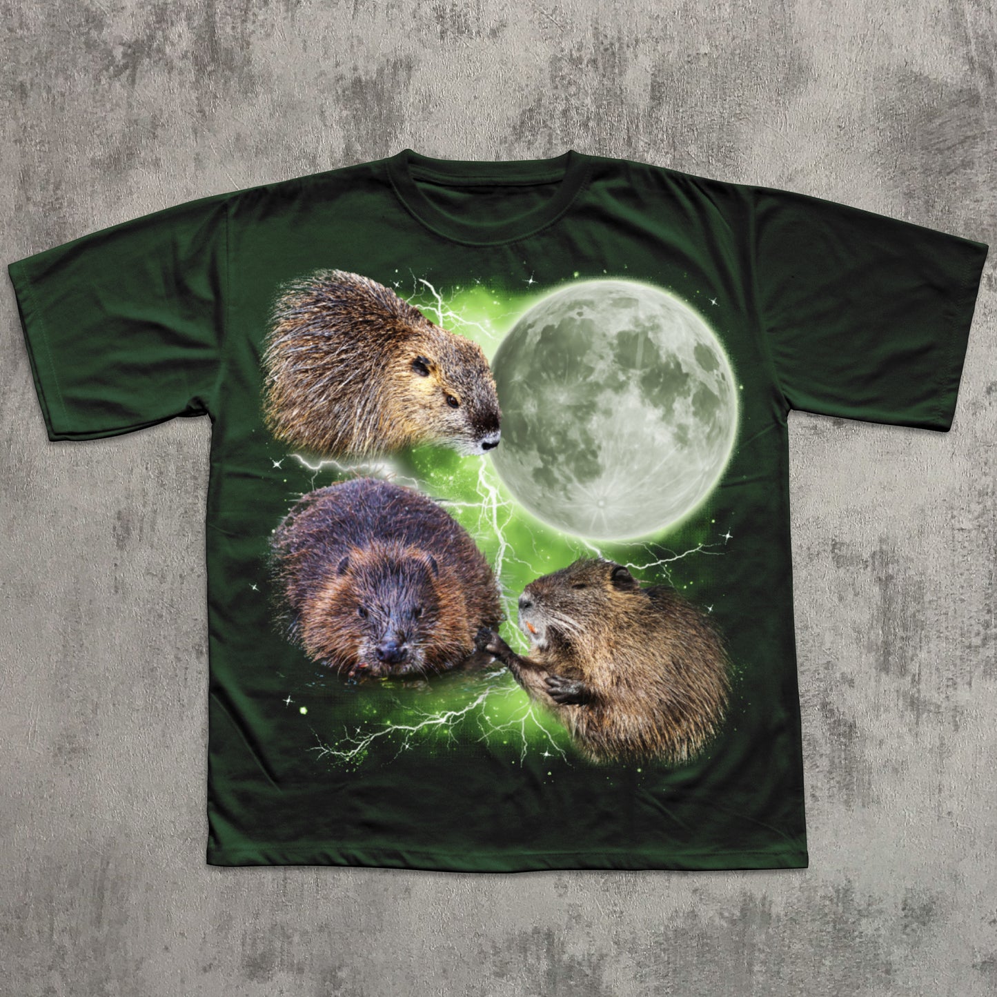 Green graphic T-shirt featuring three realistic beavers arranged around a glowing full moon with green lightning effects in the background.