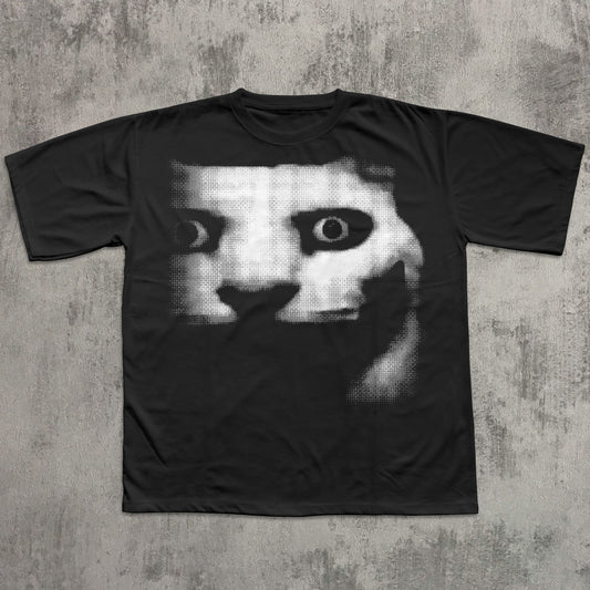 Black t-shirt with a graphic design of a face on a textured gray background