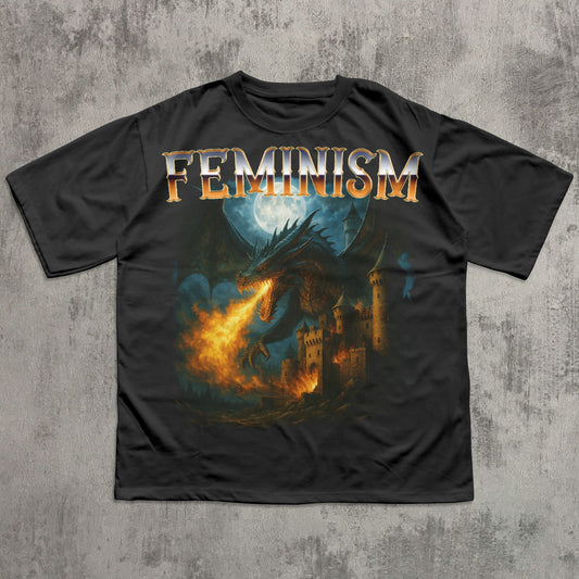Black t-shirt with a dragon and castle design and 'Feminism' text on a textured gray background