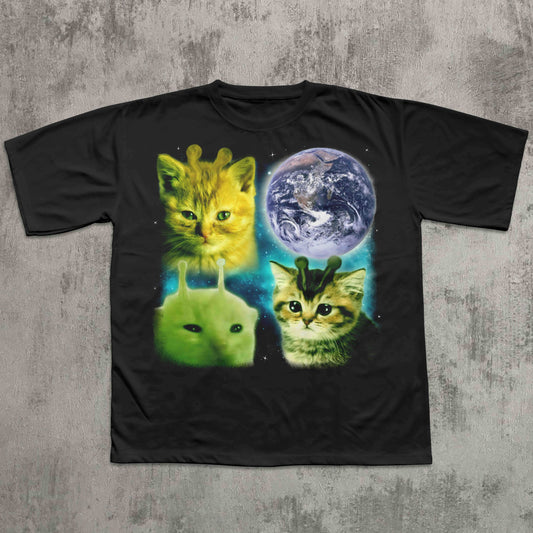 Black t-shirt with alien cats and Earth graphic on a textured gray background