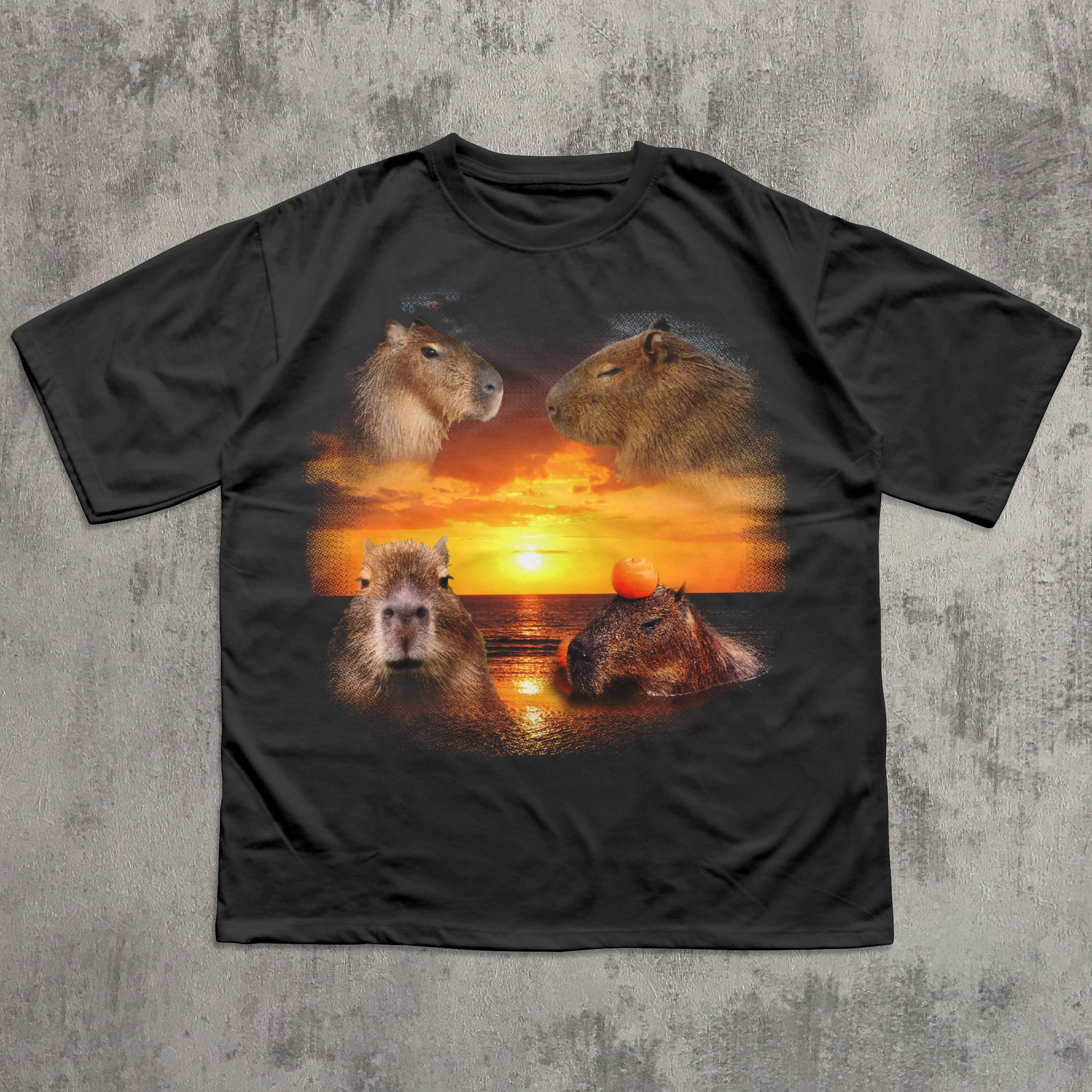 Black t-shirt with capybara design on a sunset background