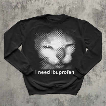 Funny black cat meme sweatshirt with halftone cat face and ‘I need ibuprofen’ text—humor graphic pullover.