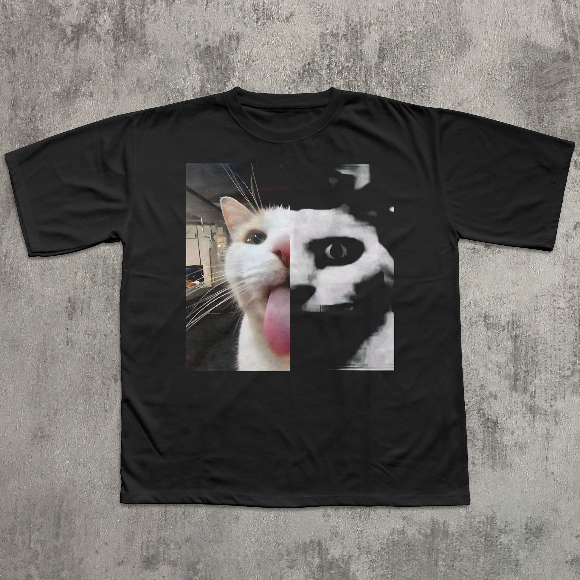 Black t-shirt with a graphic of a cat's face on a textured gray background