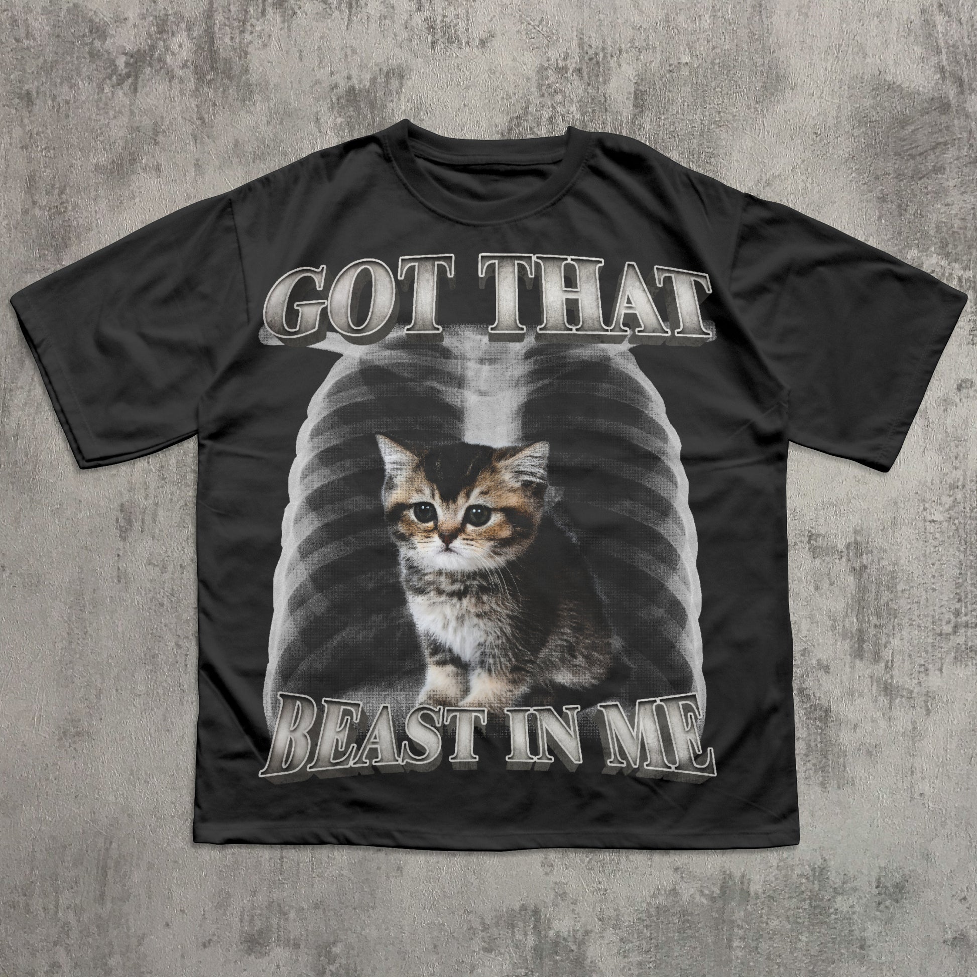 Black t-shirt with a cat graphic and text on a textured gray background