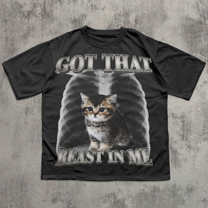 Black t-shirt with a cat graphic and text on a textured gray background