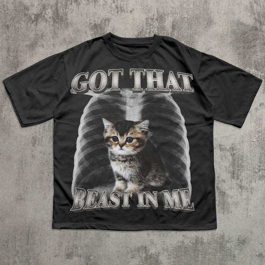 Black t-shirt with a cat graphic and text on a textured gray background