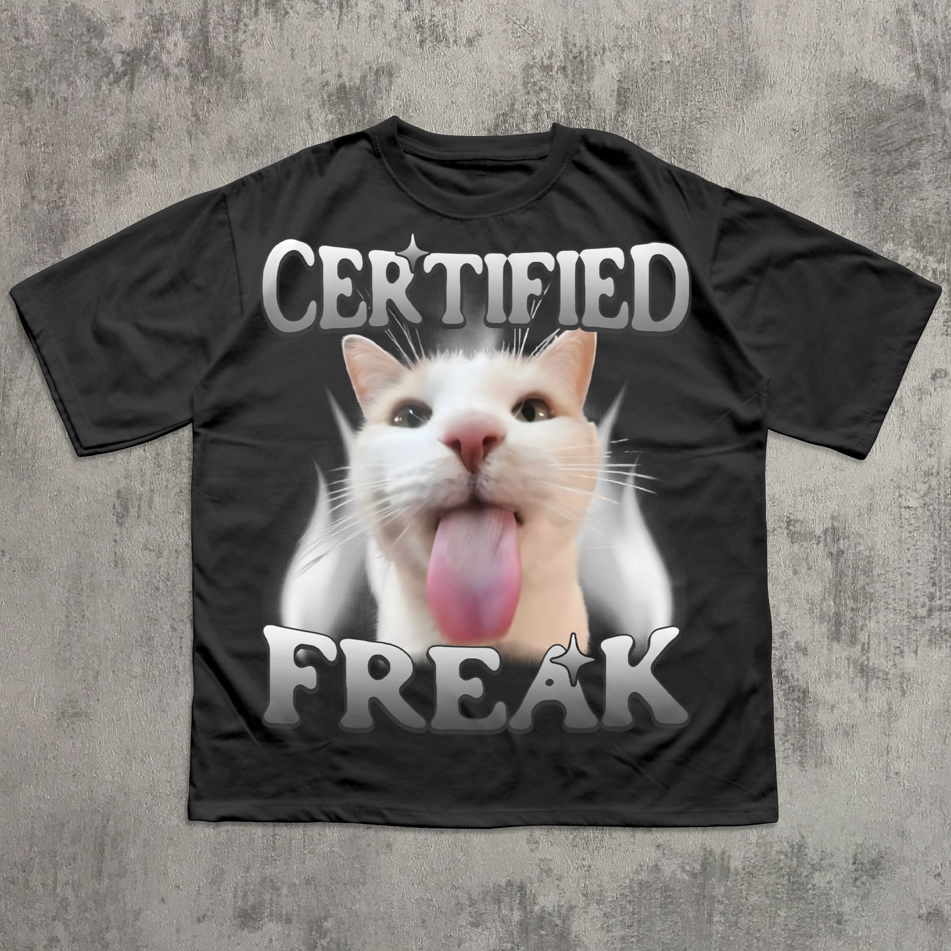 Black t-shirt with a cat graphic and 'Certified Freak' text on a concrete surface