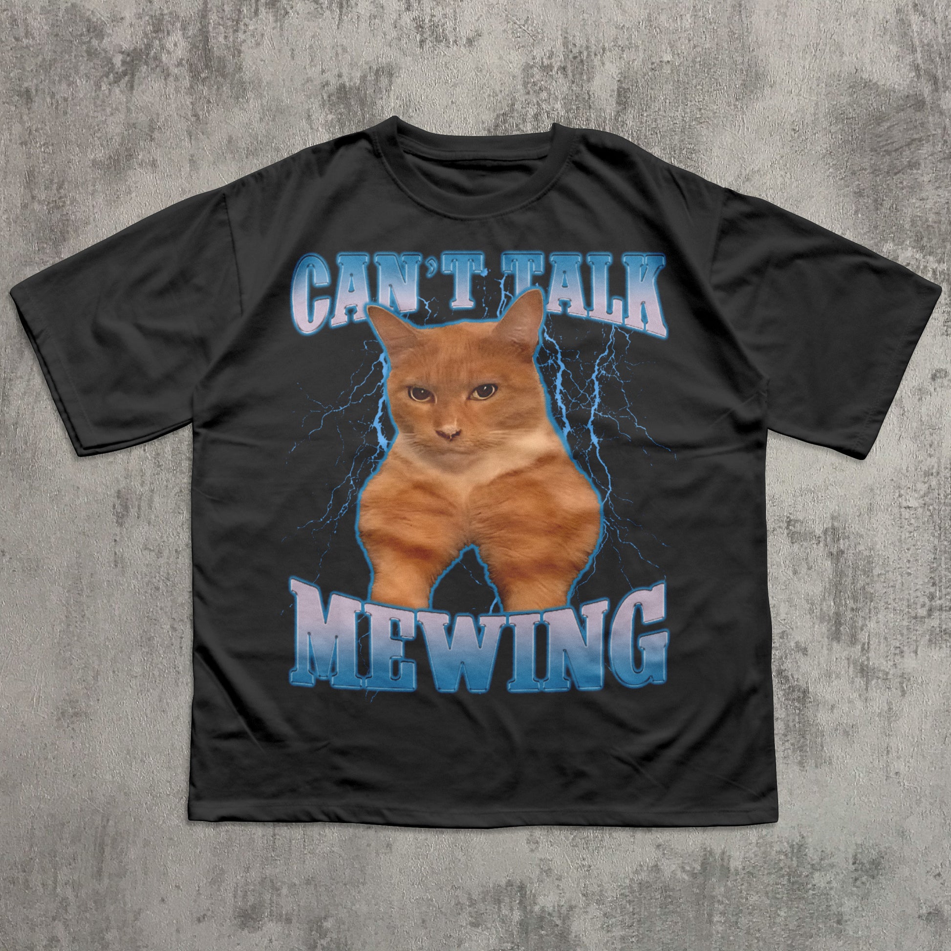 funny Black t-shirt with a cat graphic and text 'CAN'T TALK MEOWING' on a textured gray background