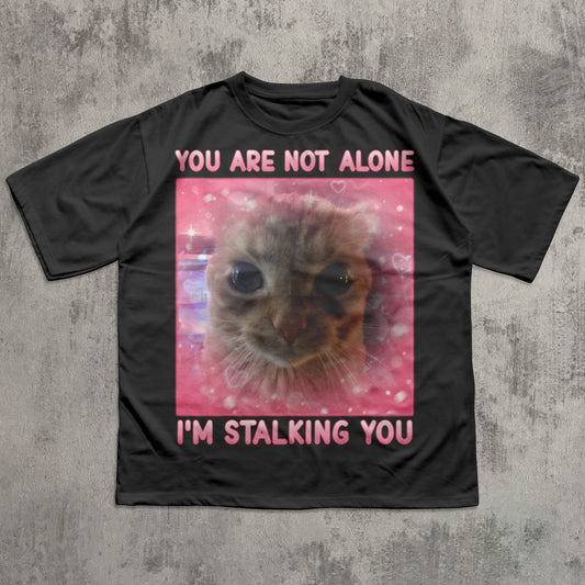 Funny Black t-shirt with a cat graphic and text on a textured gray background