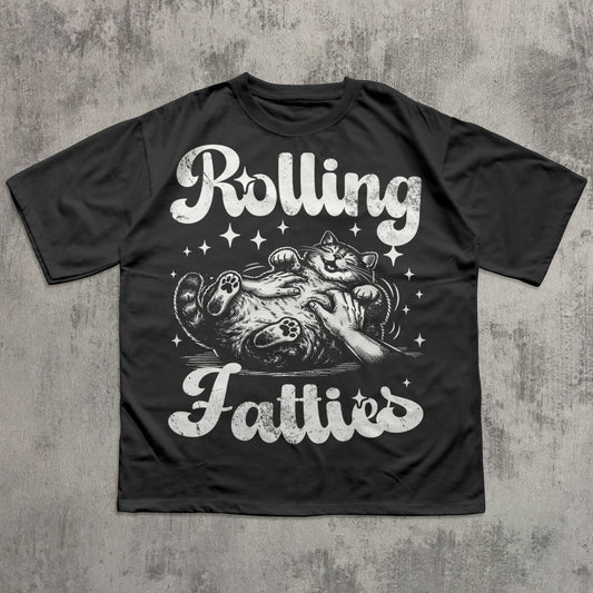 Black t-shirt with graphic design and text 'Rolling Fatties' on a textured gray background