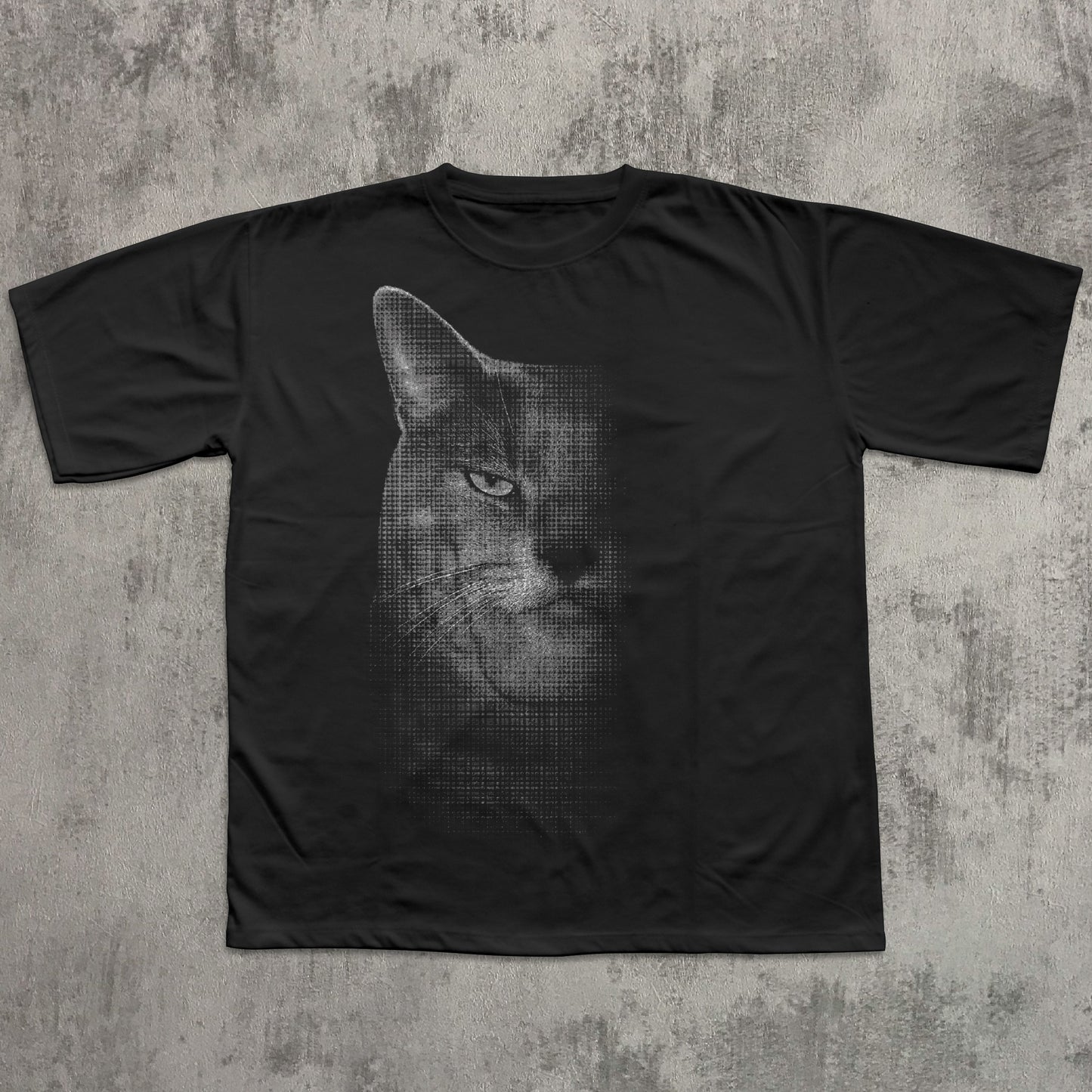 Black t-shirt with a graphic of a cat's face on a textured gray background