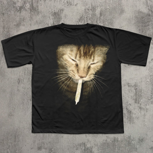 Black t-shirt with a cat graphic on a textured gray background