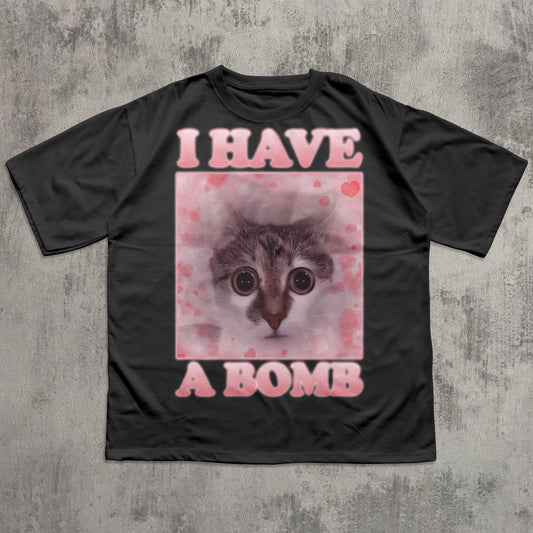 Black t-shirt with a graphic of a cat and text 'I HAVE A BOMB' on a textured gray background