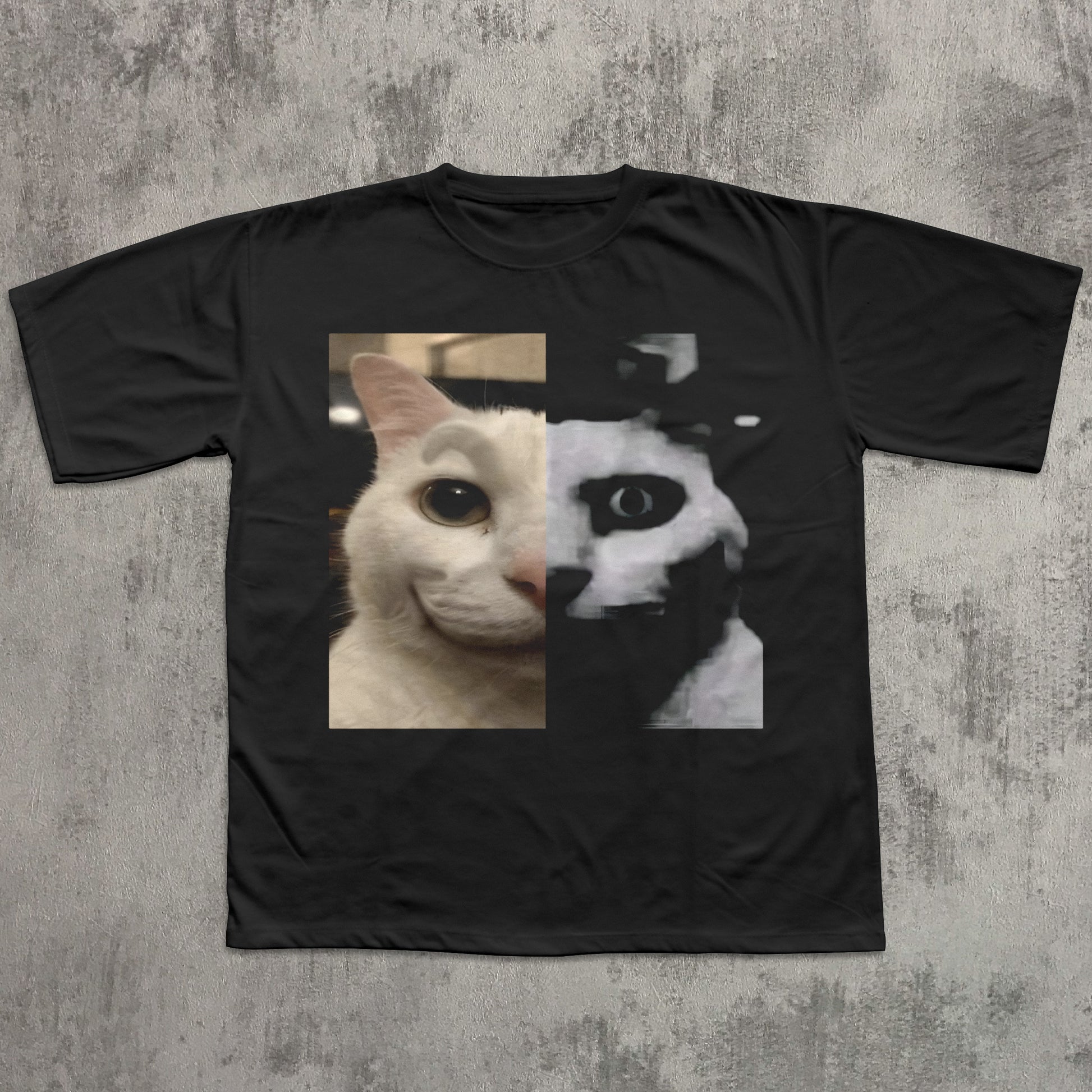 Black t-shirt with a split design of a cat's face on a textured gray background