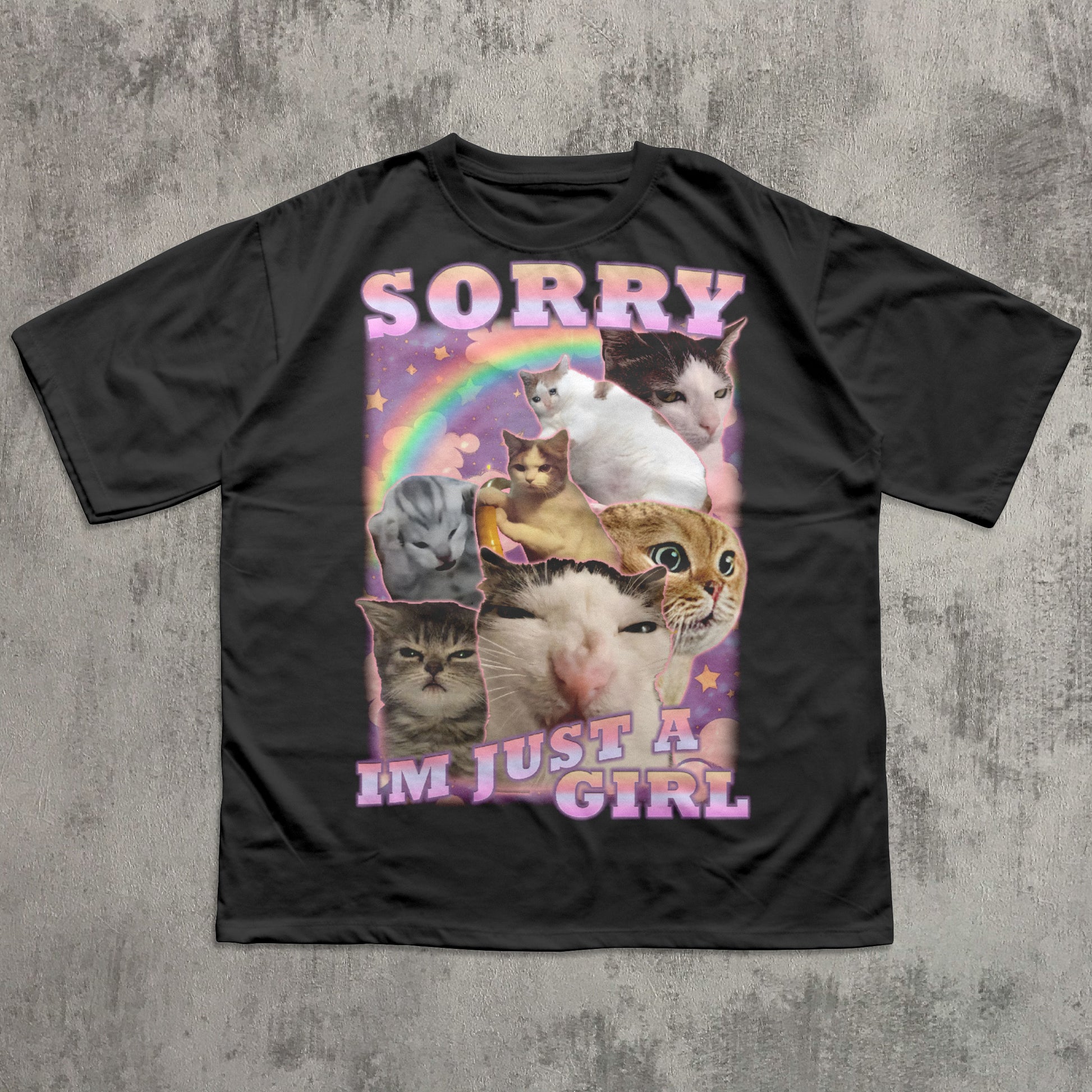 Black t-shirt with cat-themed graphic and text 'Sorry I'm just a girl' on a textured gray background