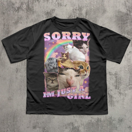 Black t-shirt with cat-themed graphic and text 'Sorry I'm just a girl' on a textured gray background