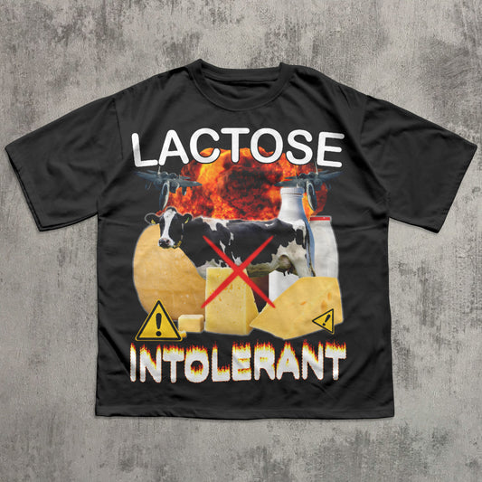 Black t-shirt with graphic design of cows, cheese, and a milk carton on a concrete background