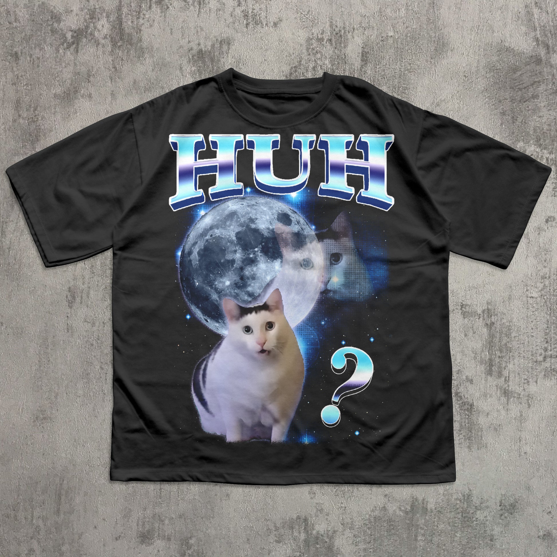Black t-shirt with a cat graphic and 'HUH?' text on a textured gray background