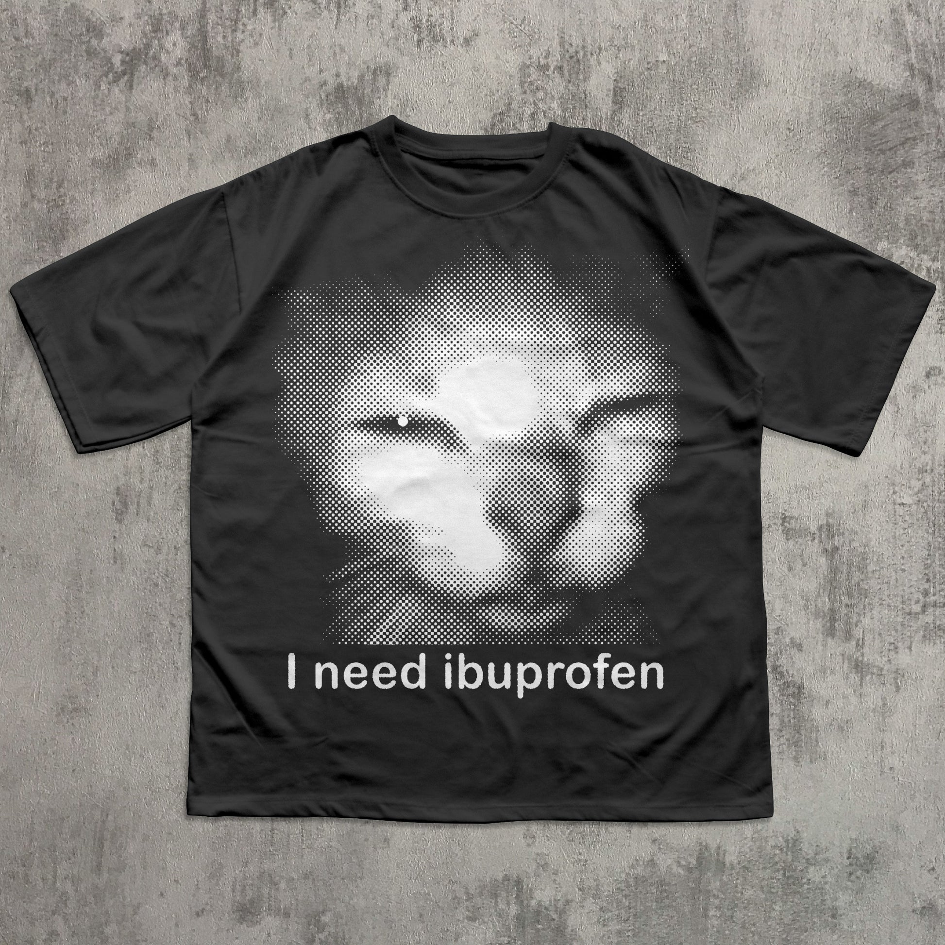 Black t-shirt with a graphic of a cat and text 'I need ibuprofen' on a textured gray background