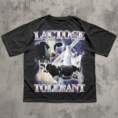Funny Black t-shirt with cow graphic and 'Lactose Tolerant' text on a concrete surface