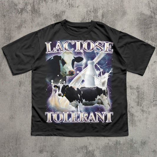 Funny Black t-shirt with cow graphic and 'Lactose Tolerant' text on a concrete surface