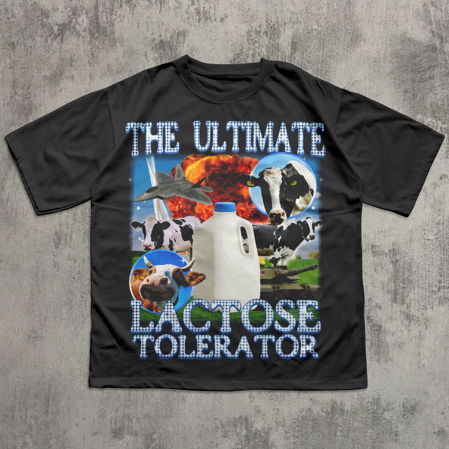 Black t-shirt with cow and milk bottle graphics and text on a concrete surface