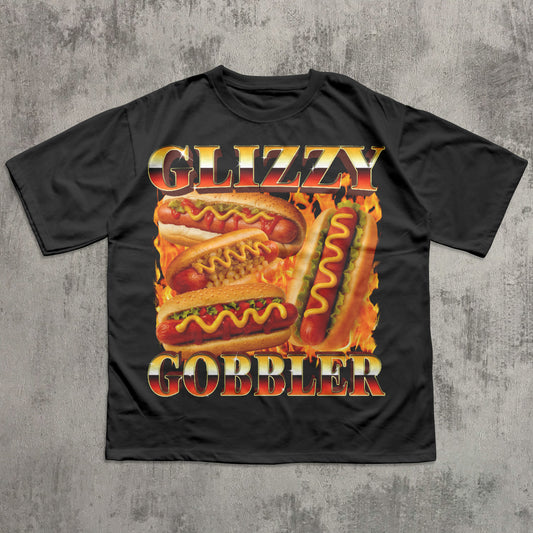 Black t-shirt with 'Glizzy Gobbler' hot dog graphic on a textured gray background