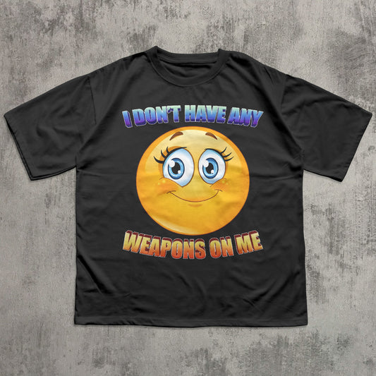 Black t-shirt with a smiley face and text on a concrete surface
