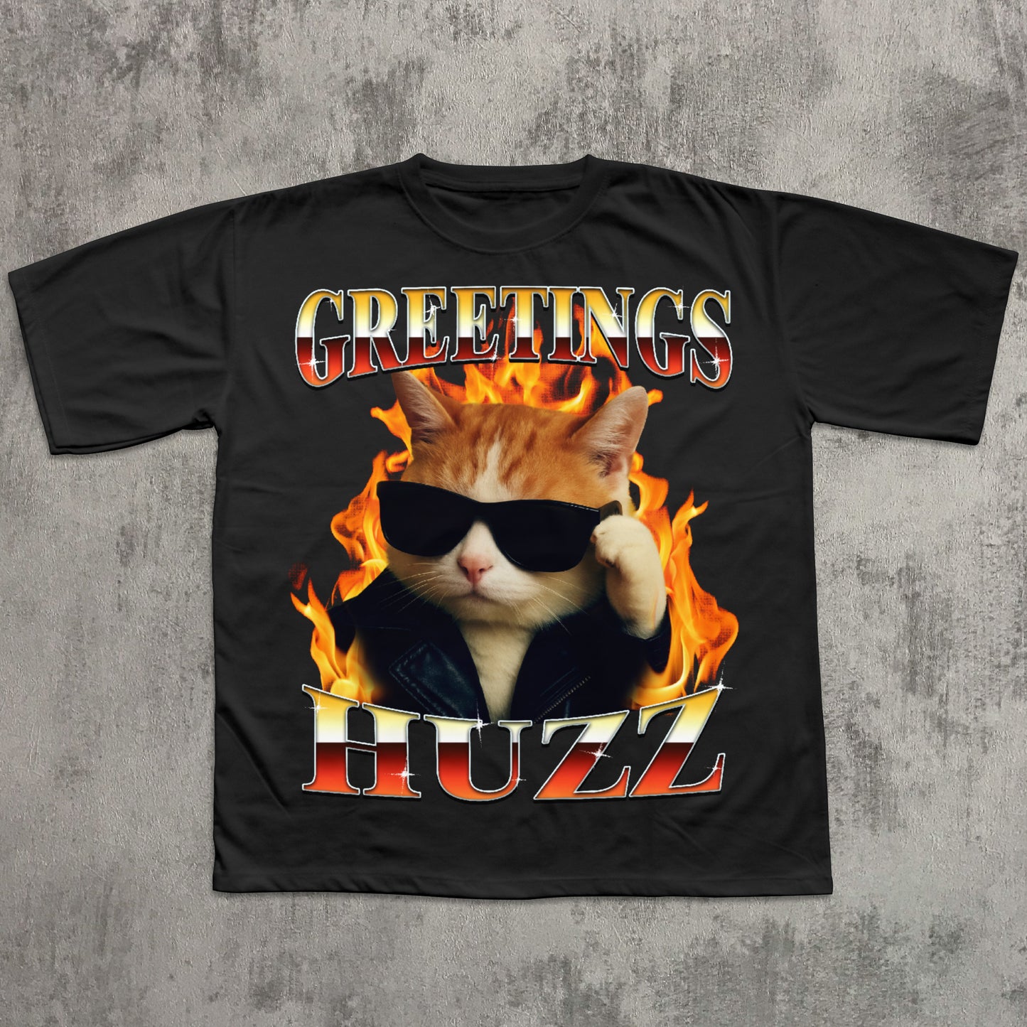 Black t-shirt with a cat in flames and 'Greetings HUZZ' text on a concrete background