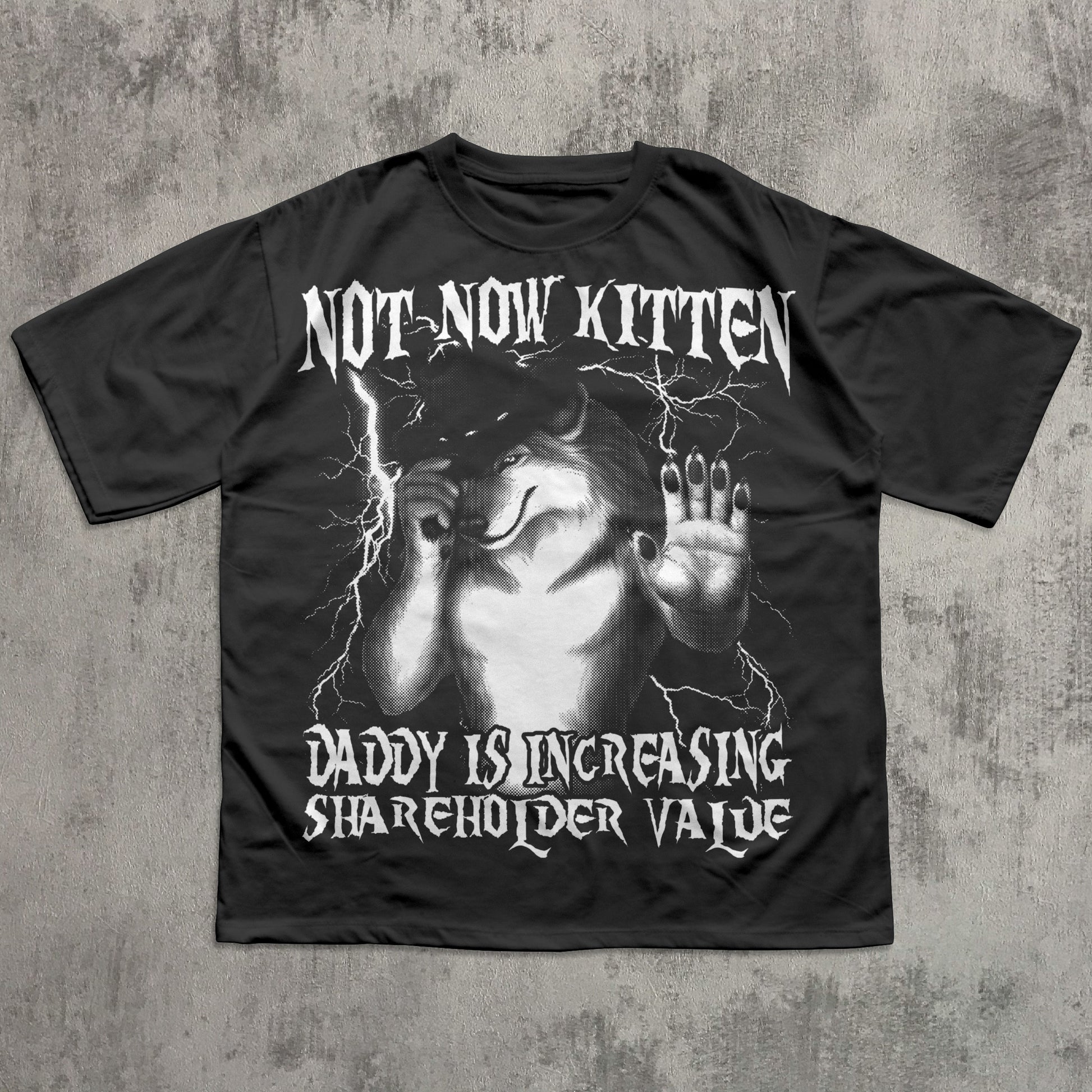 Black t-shirt with graphic design and text on a textured gray background