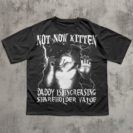 Black t-shirt with graphic design and text on a textured gray background