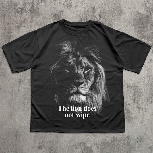 Black t-shirt with a lion graphic and text 'The lion does not wipe' on a textured gray background