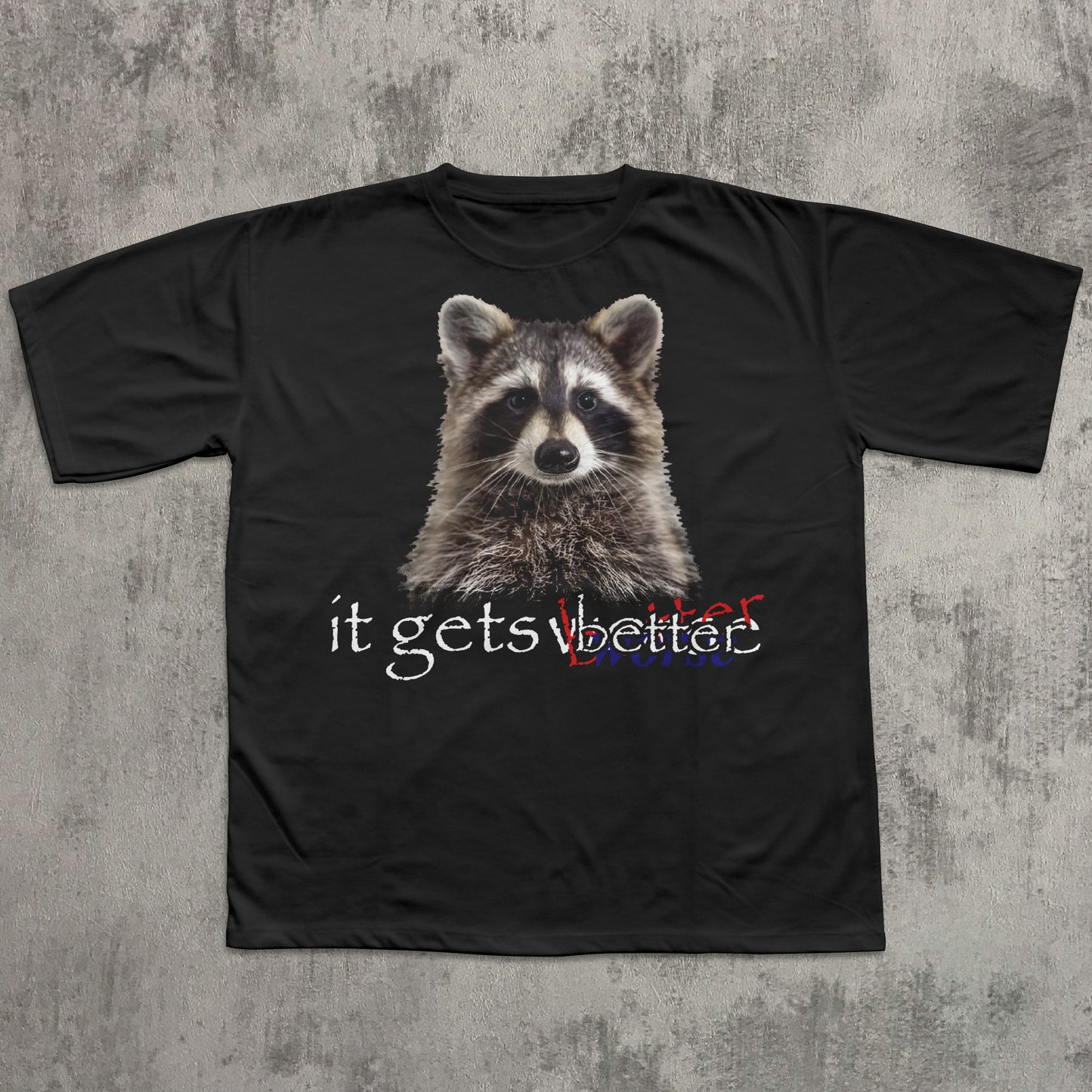 Black t-shirt with a raccoon graphic and text 'it gets better' on a textured gray background