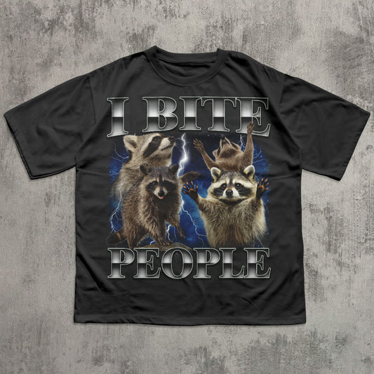 Black t-shirt with raccoon graphic and text 'I BITE PEOPLE' on a textured gray background