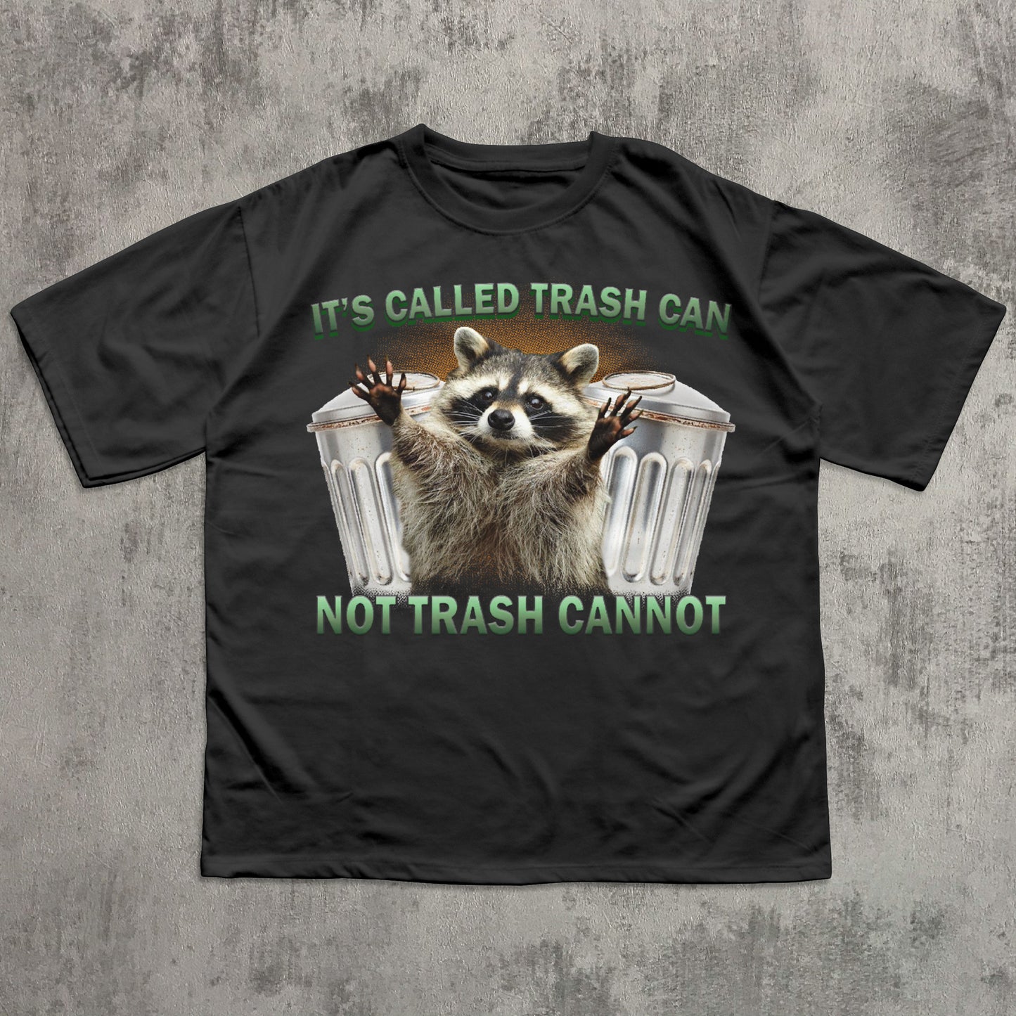Black t-shirt with a raccoon graphic and text on a textured gray background