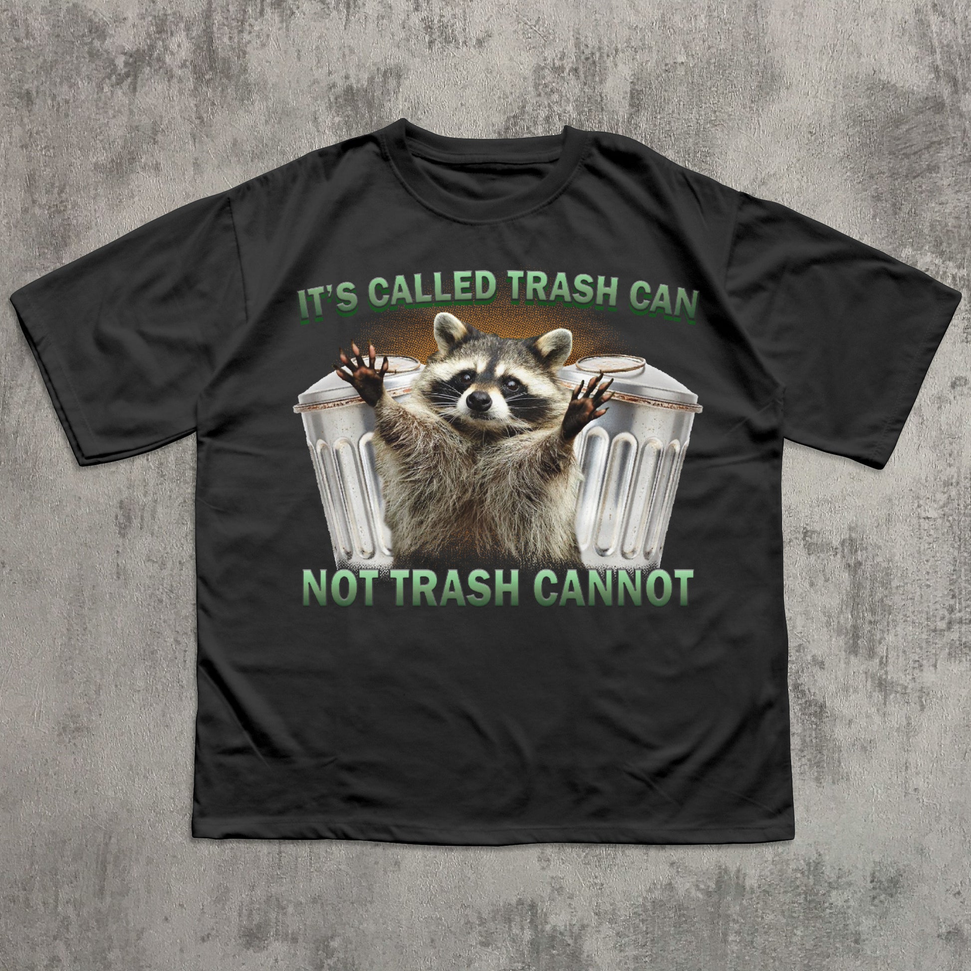 Black t-shirt with a raccoon graphic and text on a textured gray background
