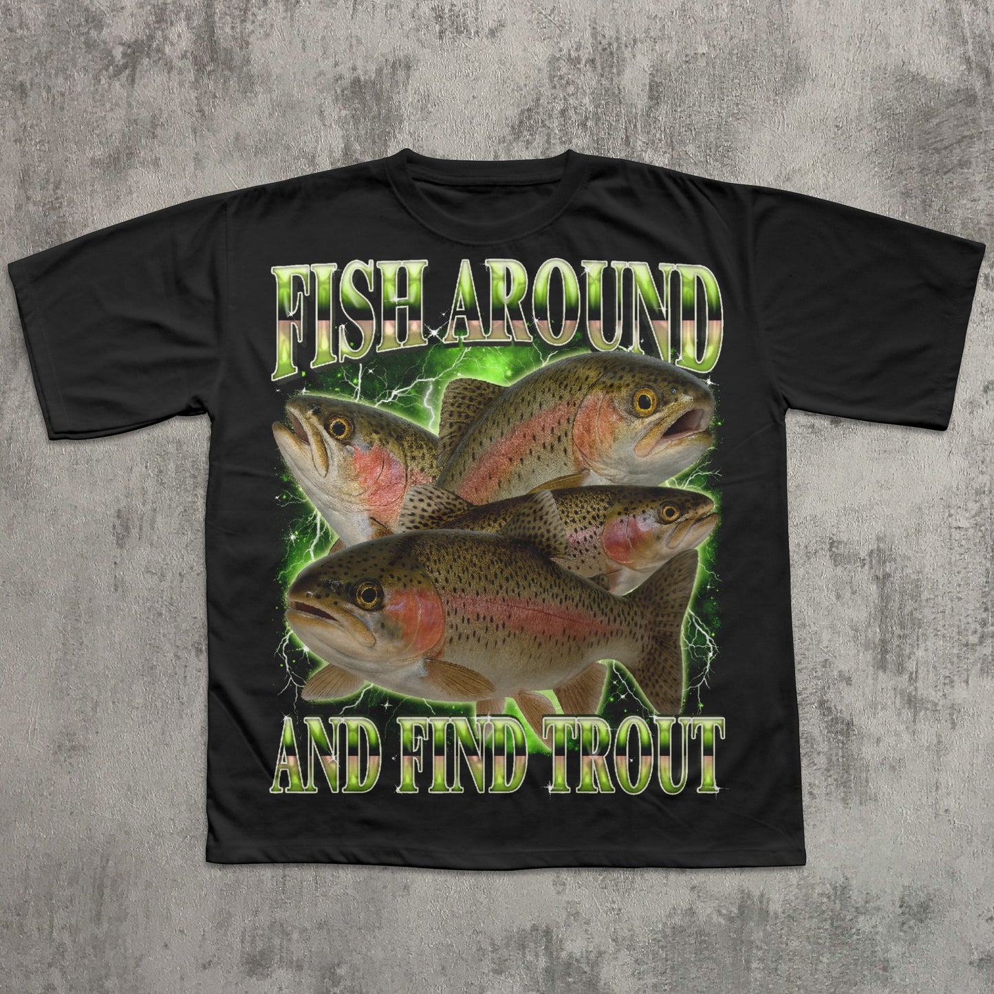 Black t-shirt with fish graphic and text 'Fish Around and Find Trout' on a textured gray background