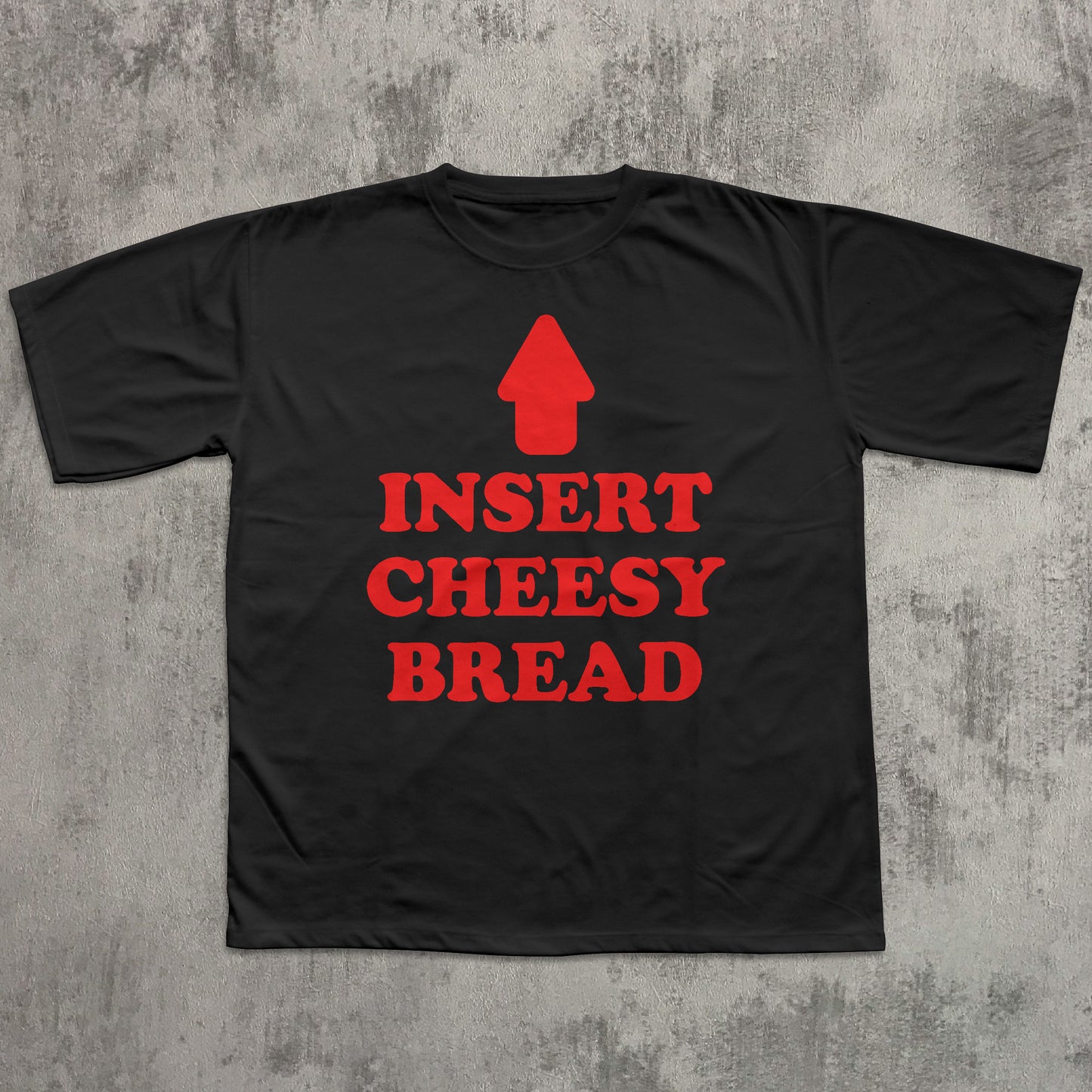 Black t-shirt with red text 'INSERT CHEESY BREAD' on a textured gray background