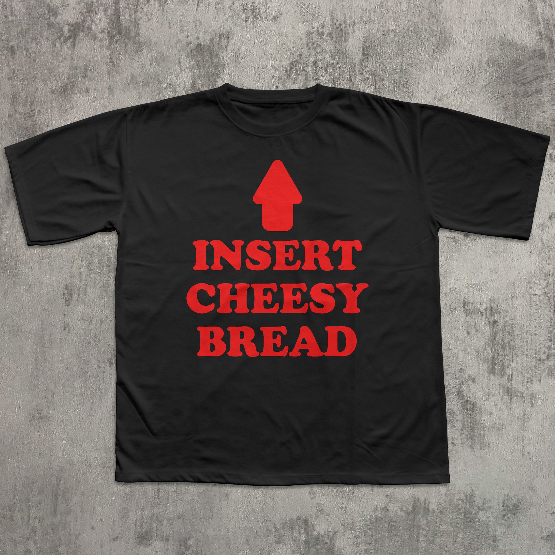 Black t-shirt with red text 'INSERT CHEESY BREAD' on a textured gray background