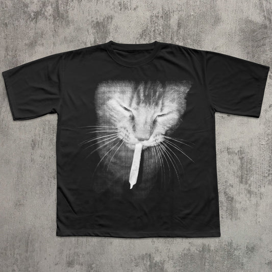 Black t-shirt with a cat graphic on a textured gray background