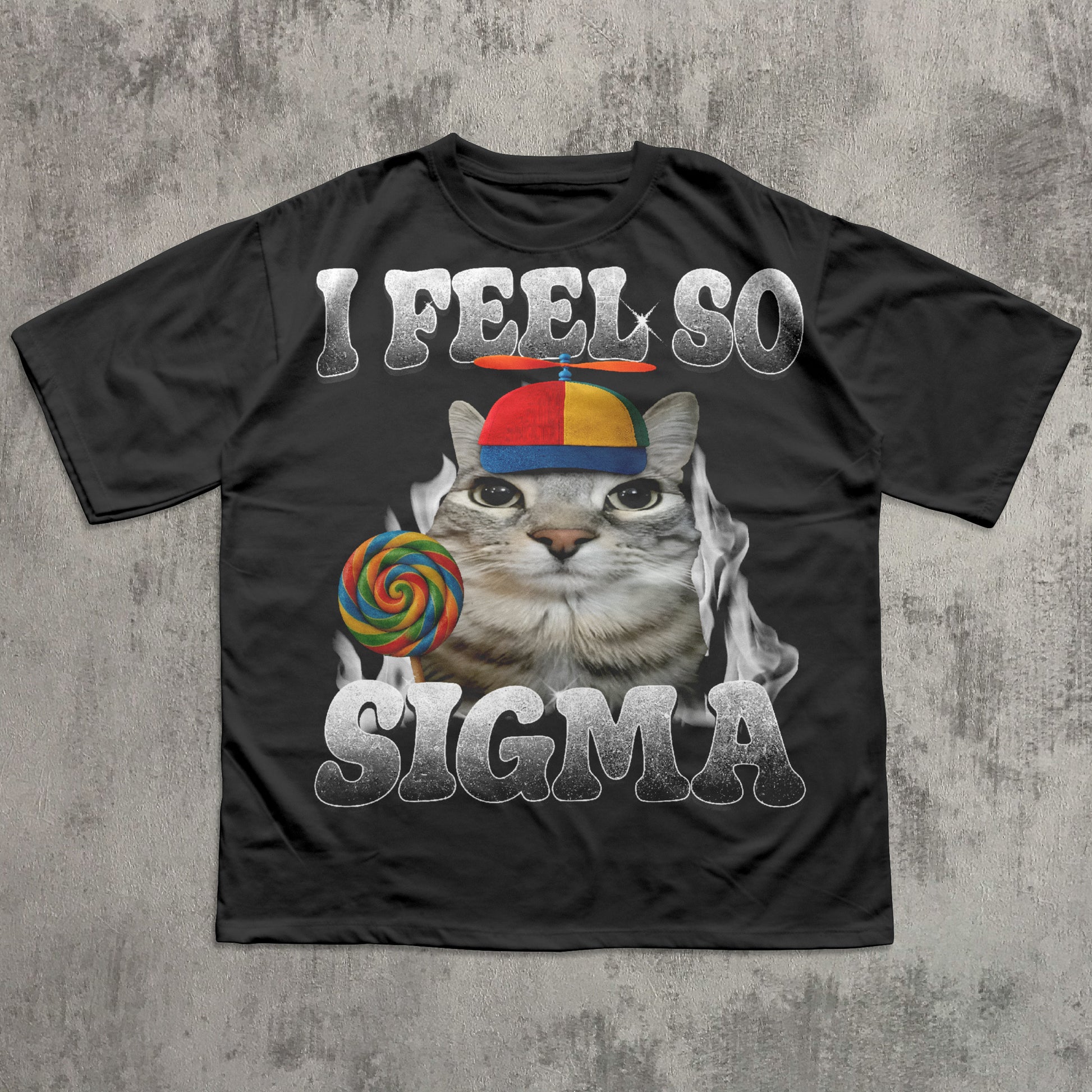 Black t-shirt with a cat meme graphic and text 'I Feel So Sigma' on a textured gray background