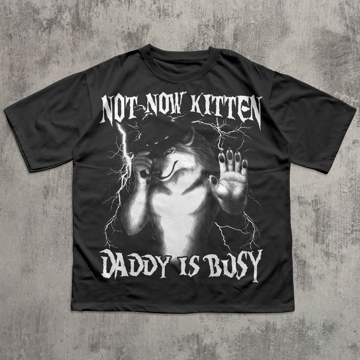Black t-shirt with graphic design and text on a textured gray background