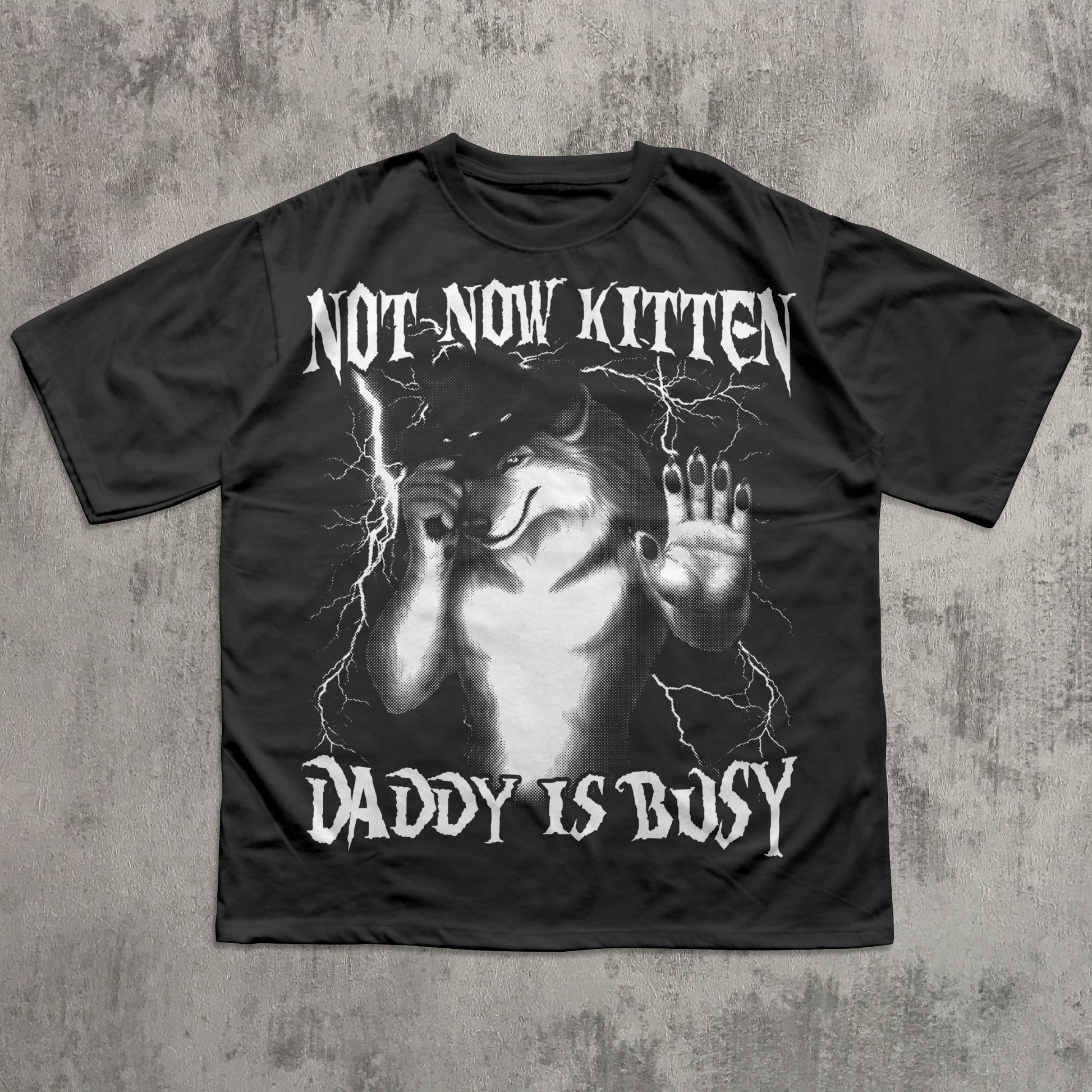 Black t-shirt with graphic design and text on a textured gray background