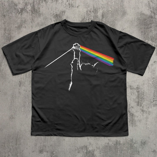 Black t-shirt with a graphic design of a rainbow on a concrete surface