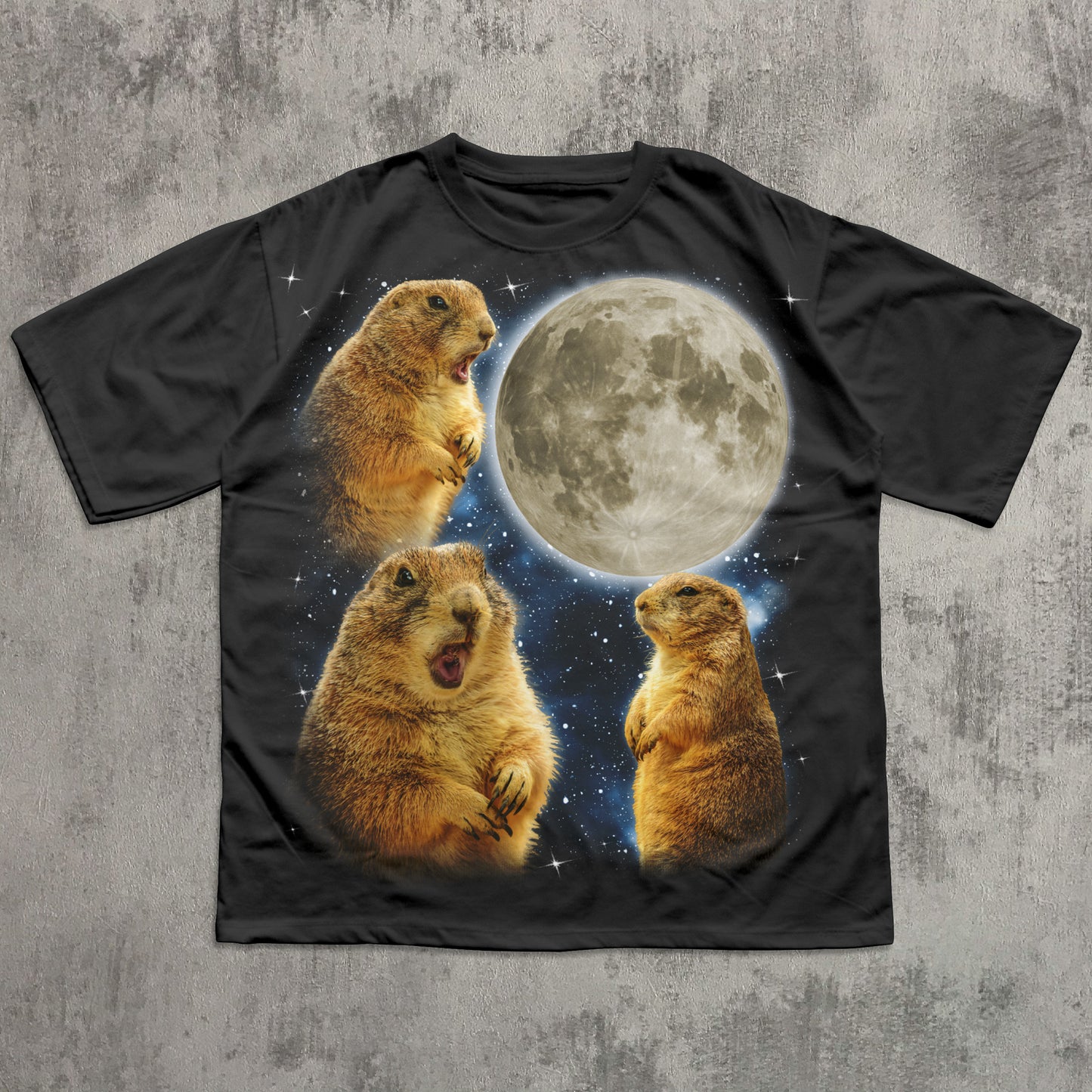 Black t-shirt with prairie dogs and a moon graphic on a textured gray background