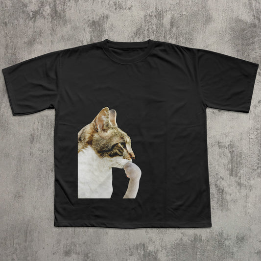 Black t-shirt with a cat graphic on a textured gray background