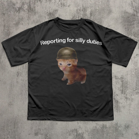 Black t-shirt with a Cat wearing a helmet and text 'Reporting for silly duties' on a textured gray background